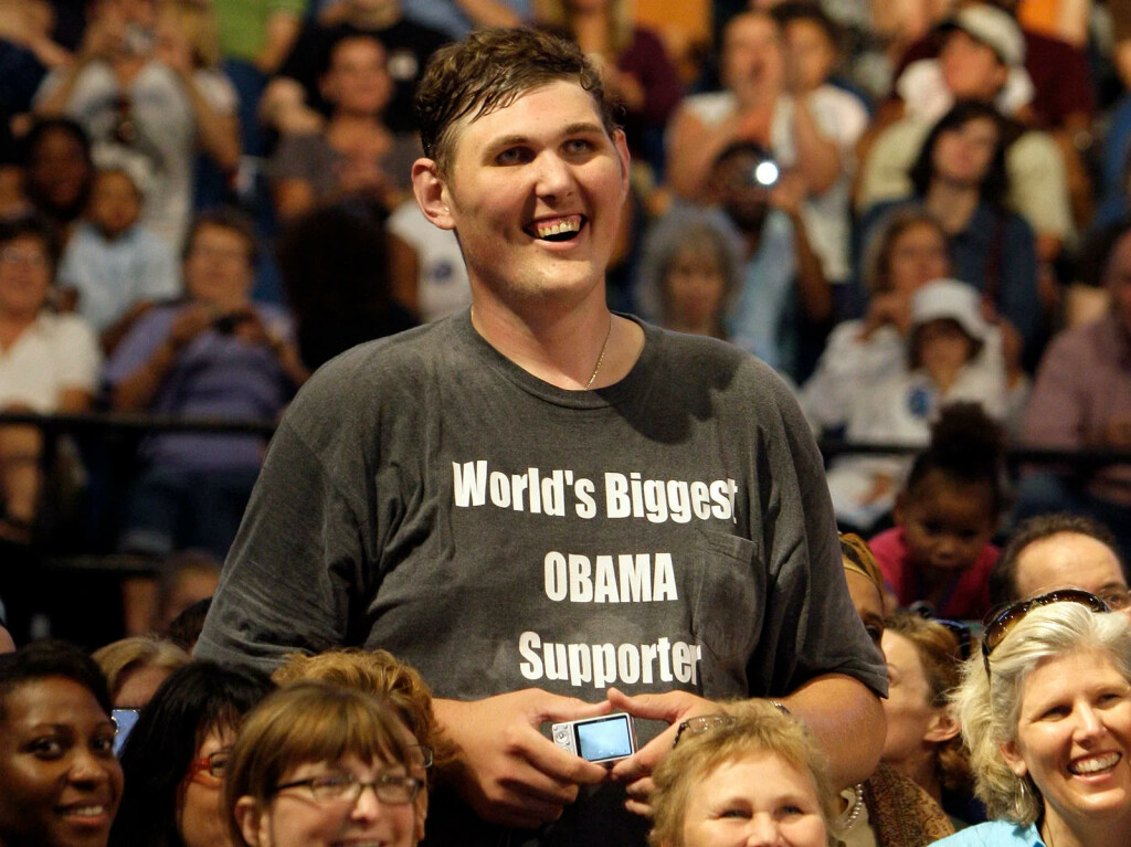 FILE - In this Sept. 12, 2009 file photo, Igor Vovkovinskiy, 27, of  Rochester, Minn, standing 7-feet and 8-inches tall,  listens to President Barack Obama, not pictured, during a health insurance reform rally in Minneapolis.  Vovkovinskiy, the tallest man in the United States, has died in Minnesota. He was 38. His family says the Ukrainian-born Vovkovinskiy died of heart disease Friday, Aug. 20, 2021, at the Mayo Clinic in Rochester.  (AP Photo/Haraz N. Ghanbari, File)