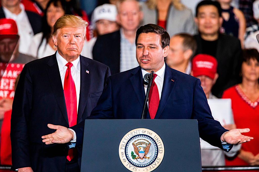 PENSACOLA, FL - NOVEMBER 03:  Florida Republican gubernatorial candidate Ron DeSantis speaks with U.S. President Donald Trump at a campaign rally at the Pensacola International Airport on November 3, 2018 in Pensacola, Florida. President Trump is campaigning in support of Republican candidates in the upcoming midterm elections. (Photo by Mark Wallheiser/Getty Images)